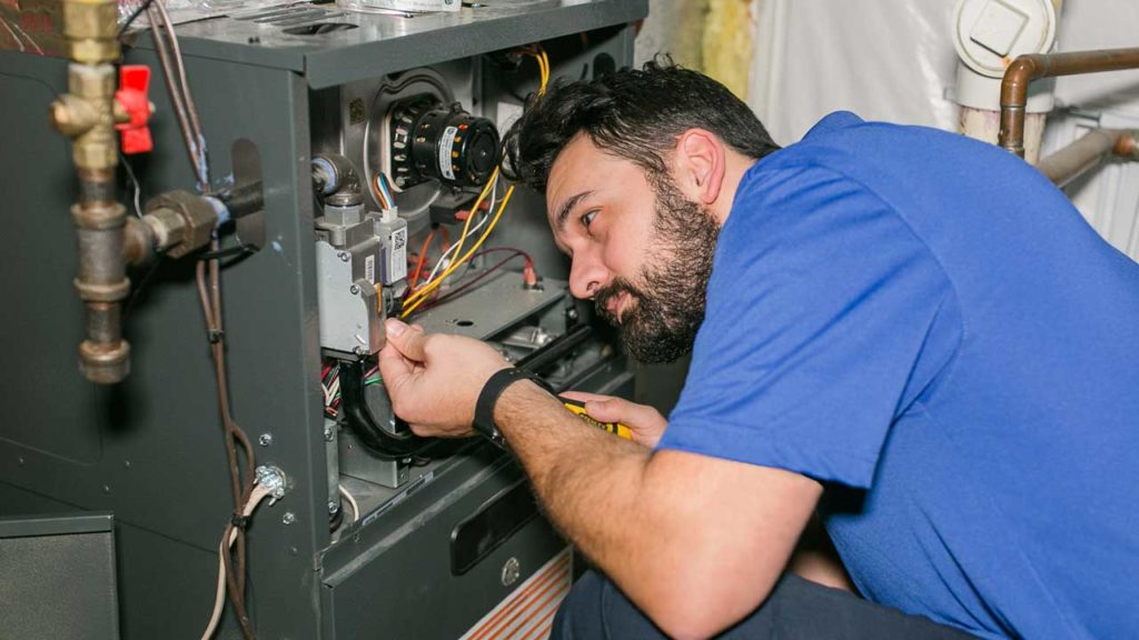 HVAC Tech fixing furnace