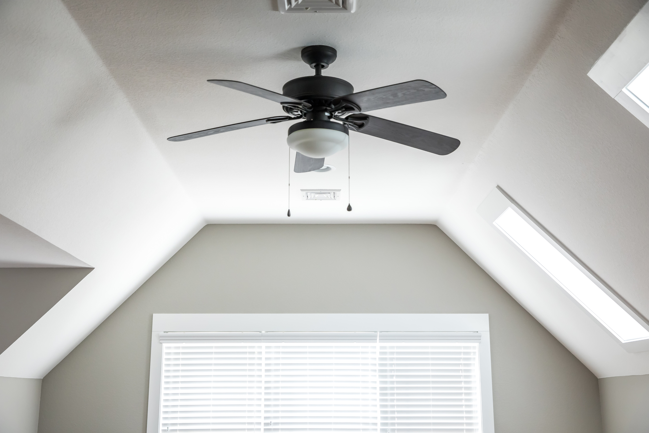 Ceiling fan in front of window